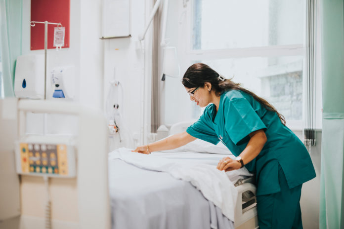 Nurse,Making,The,Bed,At,A,Hospital